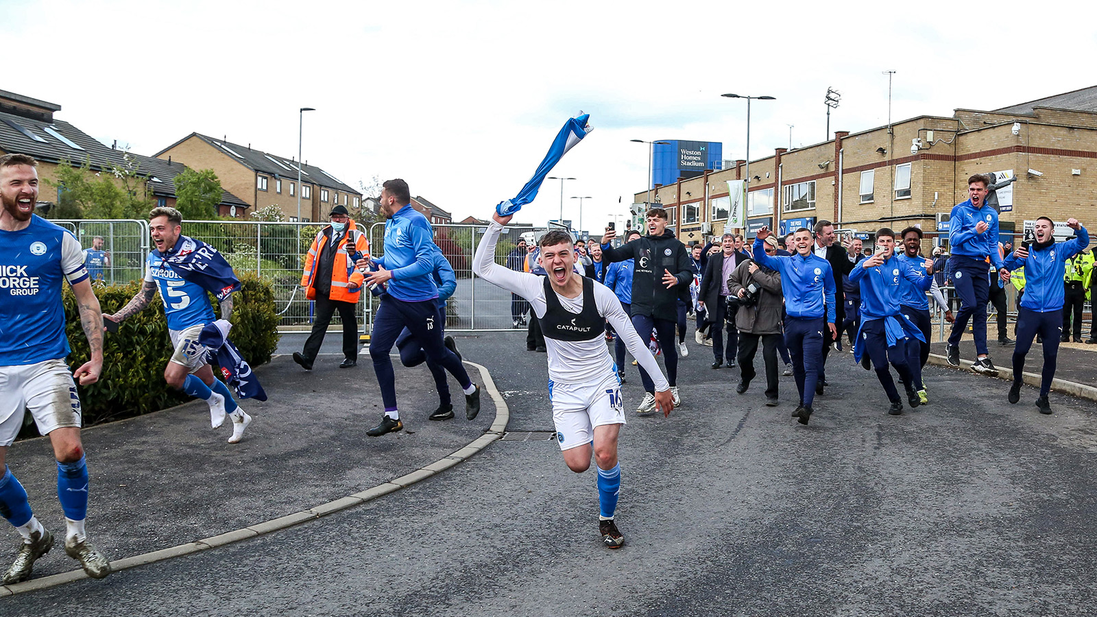 1st May '21 | Harrison Burrows rushes to share celebrating promotion with supporters outside the Weston Homes Stadium