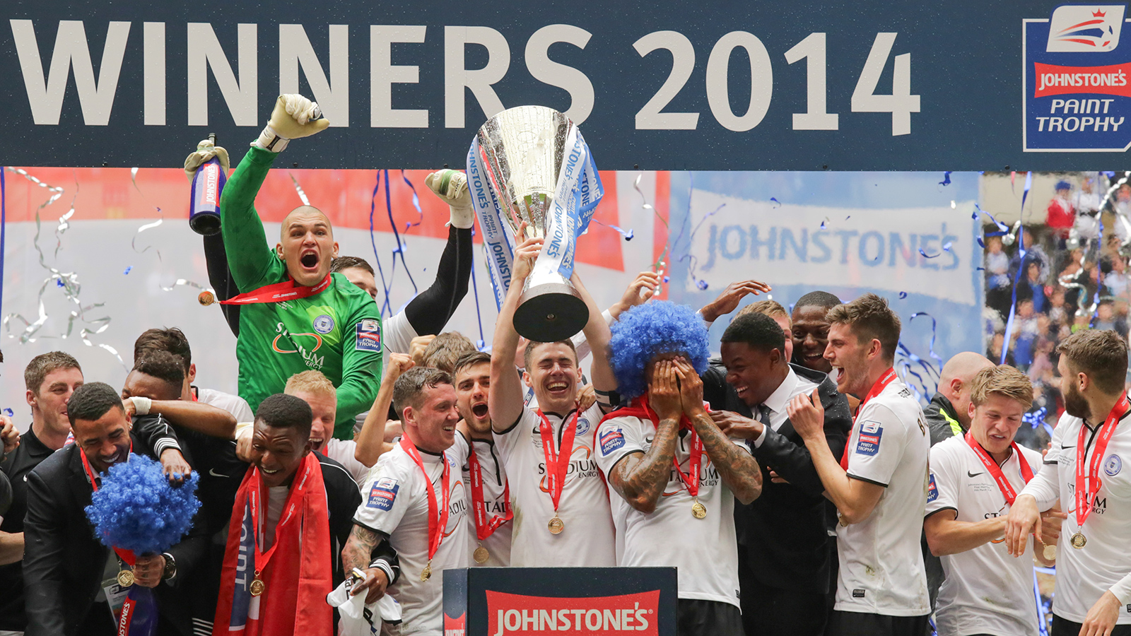 Peterborough United players celebrate winning the Johnstone's Paint Tropy