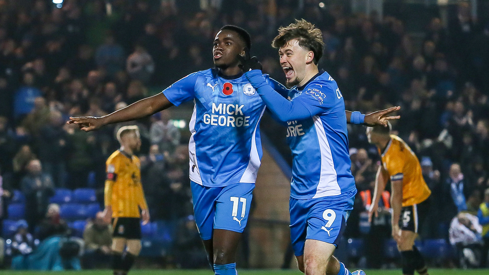 Kwame Poku celebrates scoring against Cambridge United