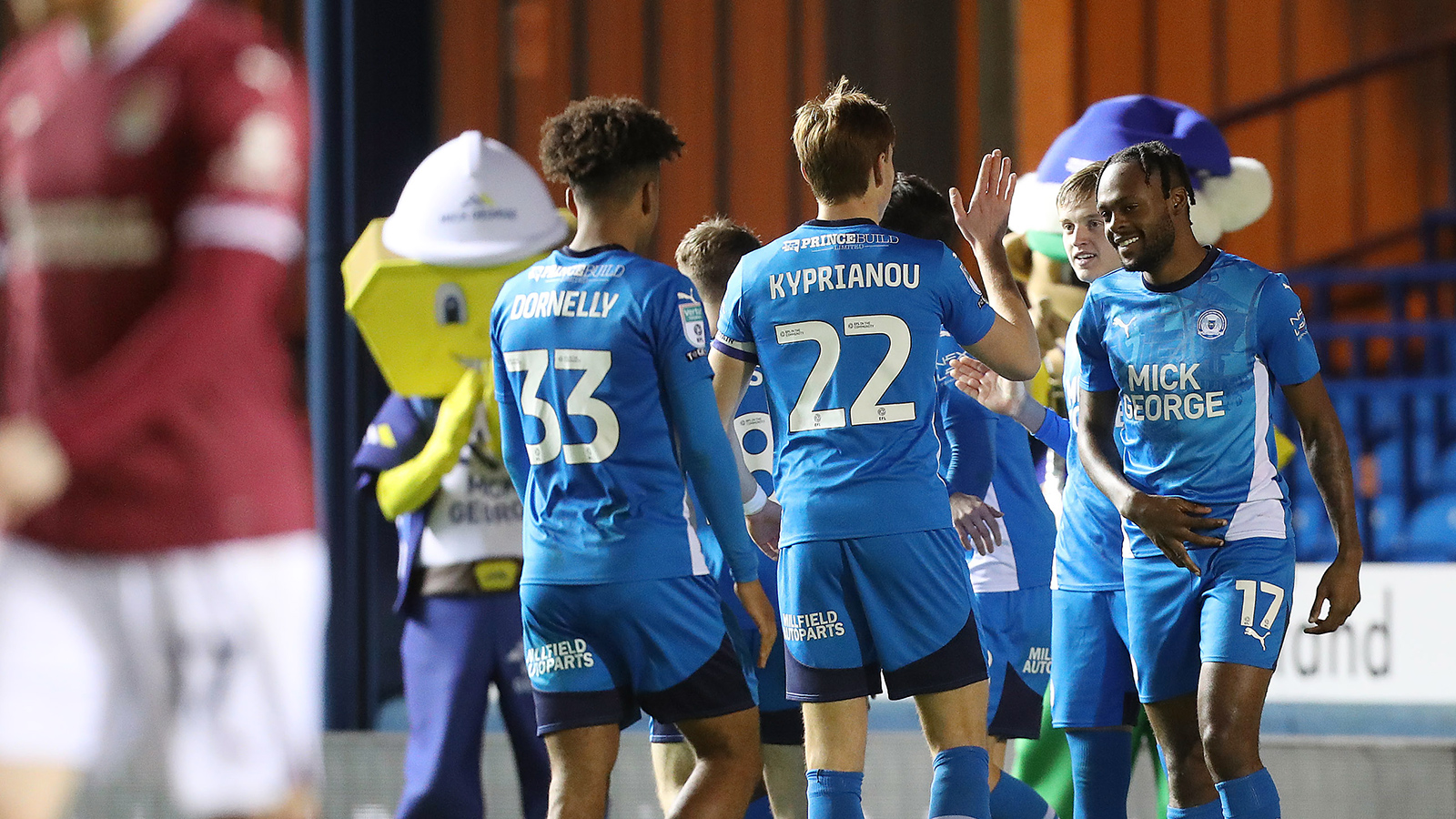 Posh players celebrate the opening goal against Northampton Town