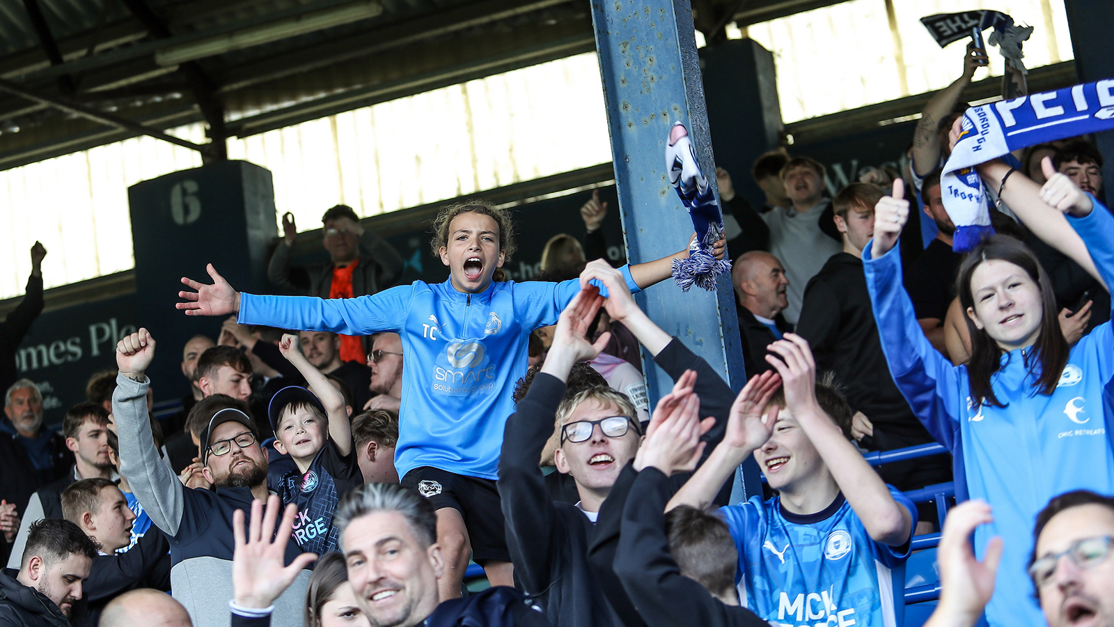 Posh fans celebrate a goal