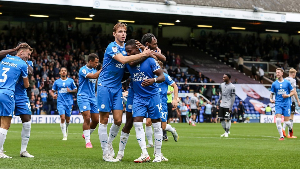 Posh players celebrate scoring against Bristol Rovers