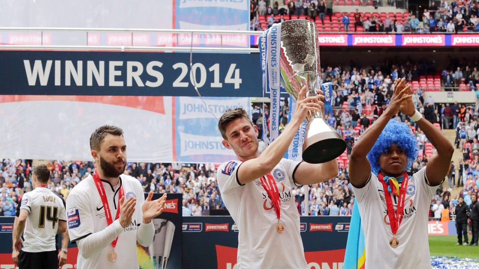 Shaun Brisley shows off the Johnstone's Paint Trophy after scoring in the final
