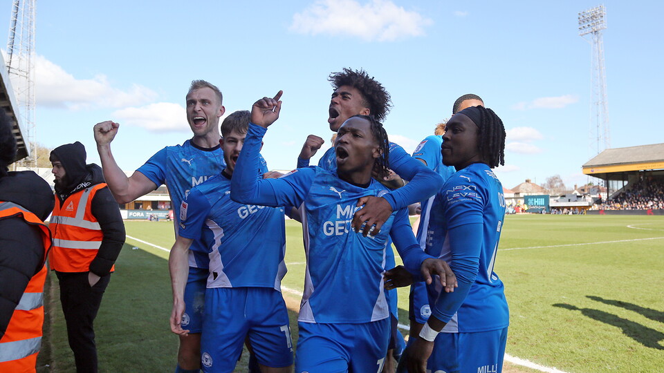 Tayo Edun and team-mates celebrate the winning goal at Cambridge United
