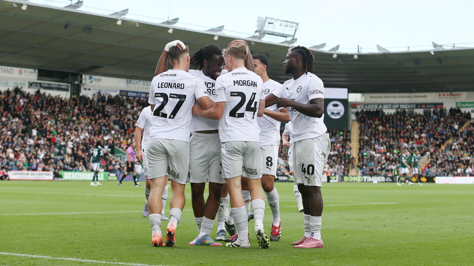 The Posh players celebrate scoring against Plymouth Argyle