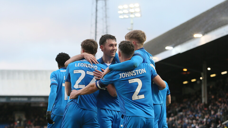 Posh players celebrate scoring against Bolton Wanderers