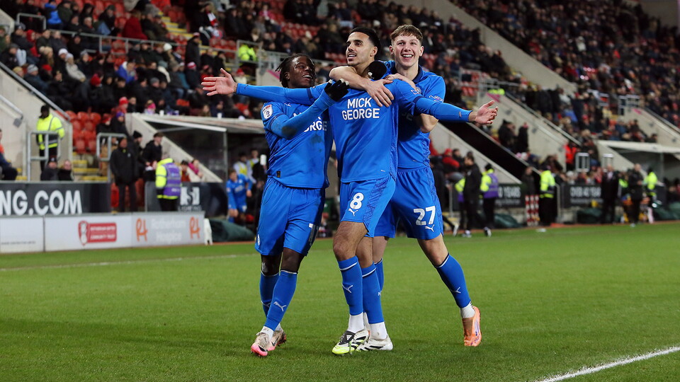 Posh players celebrate scoring at Rotherham United