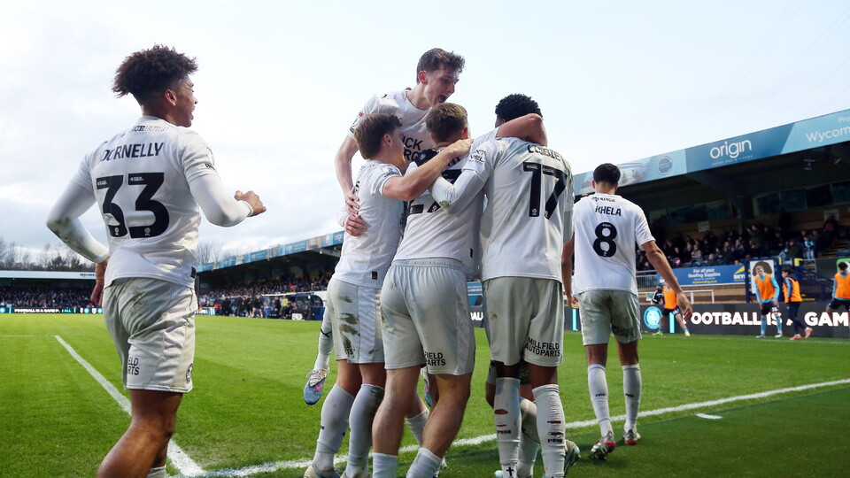 Posh players celebrate scoring against Wycombe Wanderers