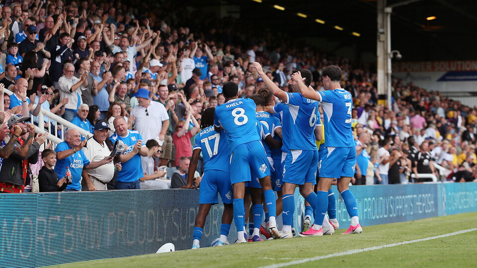 Posh players celebrate the winner against Mansfield Town